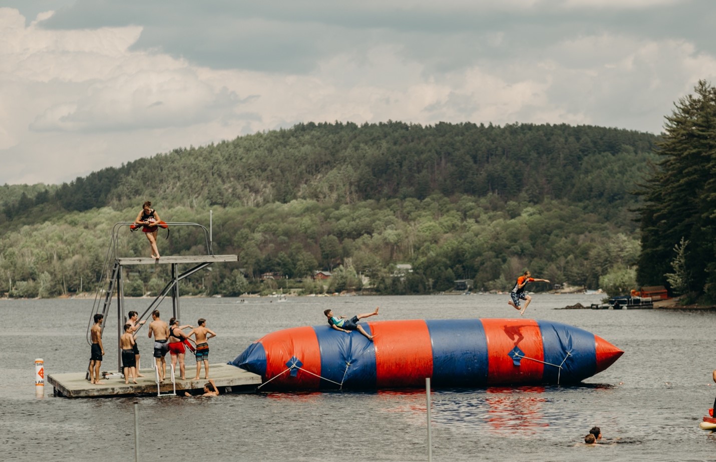 Photo courtesy of Word of Life - Students playing on blog in a lake